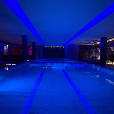 Blue-lit indoor spa pool at Grand Hotel Victoria on Lake Como